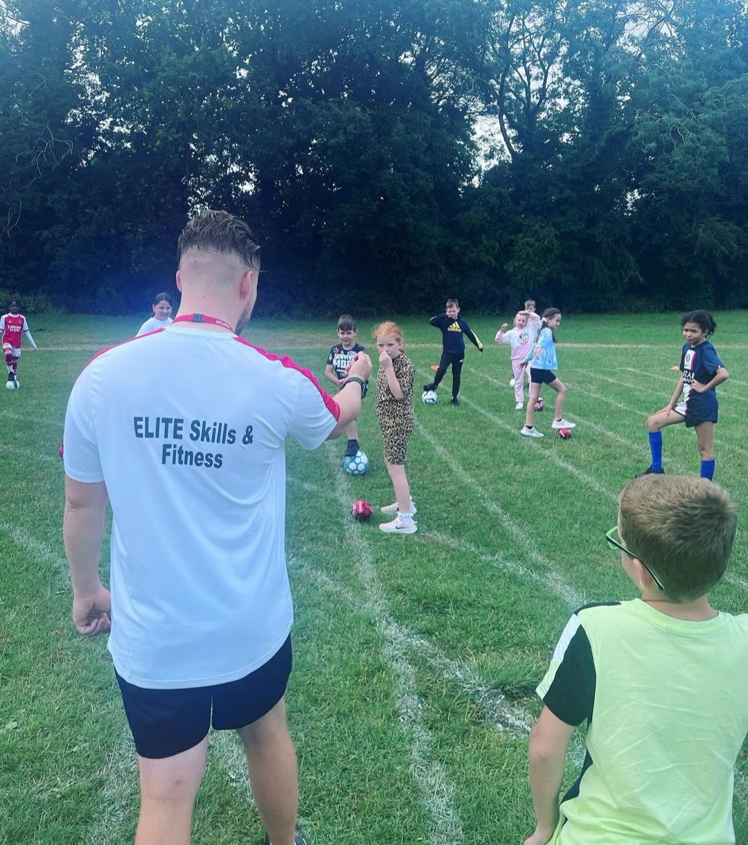 A coach working one to one with a young footballer