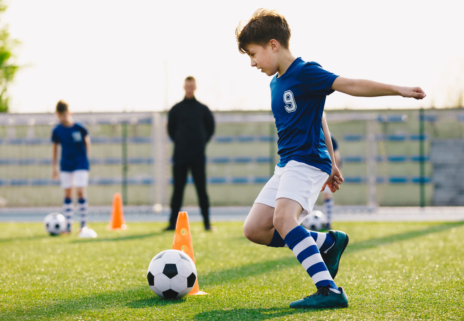 Elite SF coaches running a small group football session