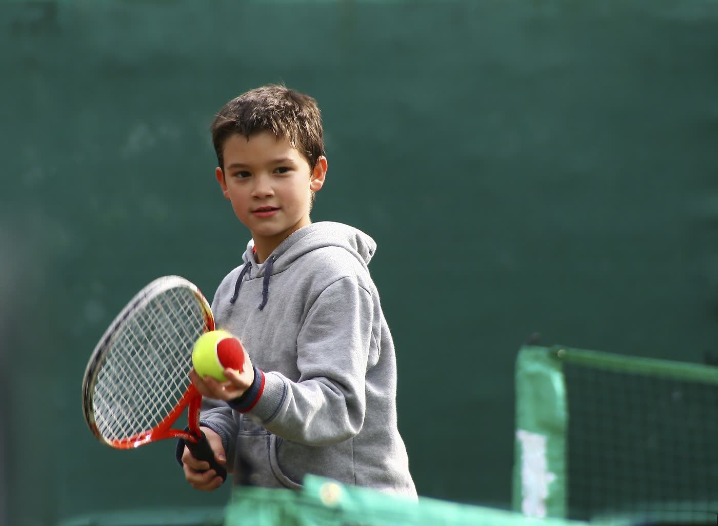 A young tennis player mid-session